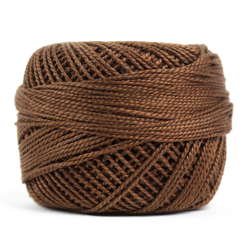 Side view of Perle cotton ball on white background to show color