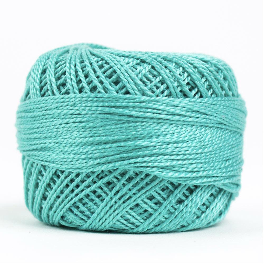 Side view of Perle cotton ball on white background to show color