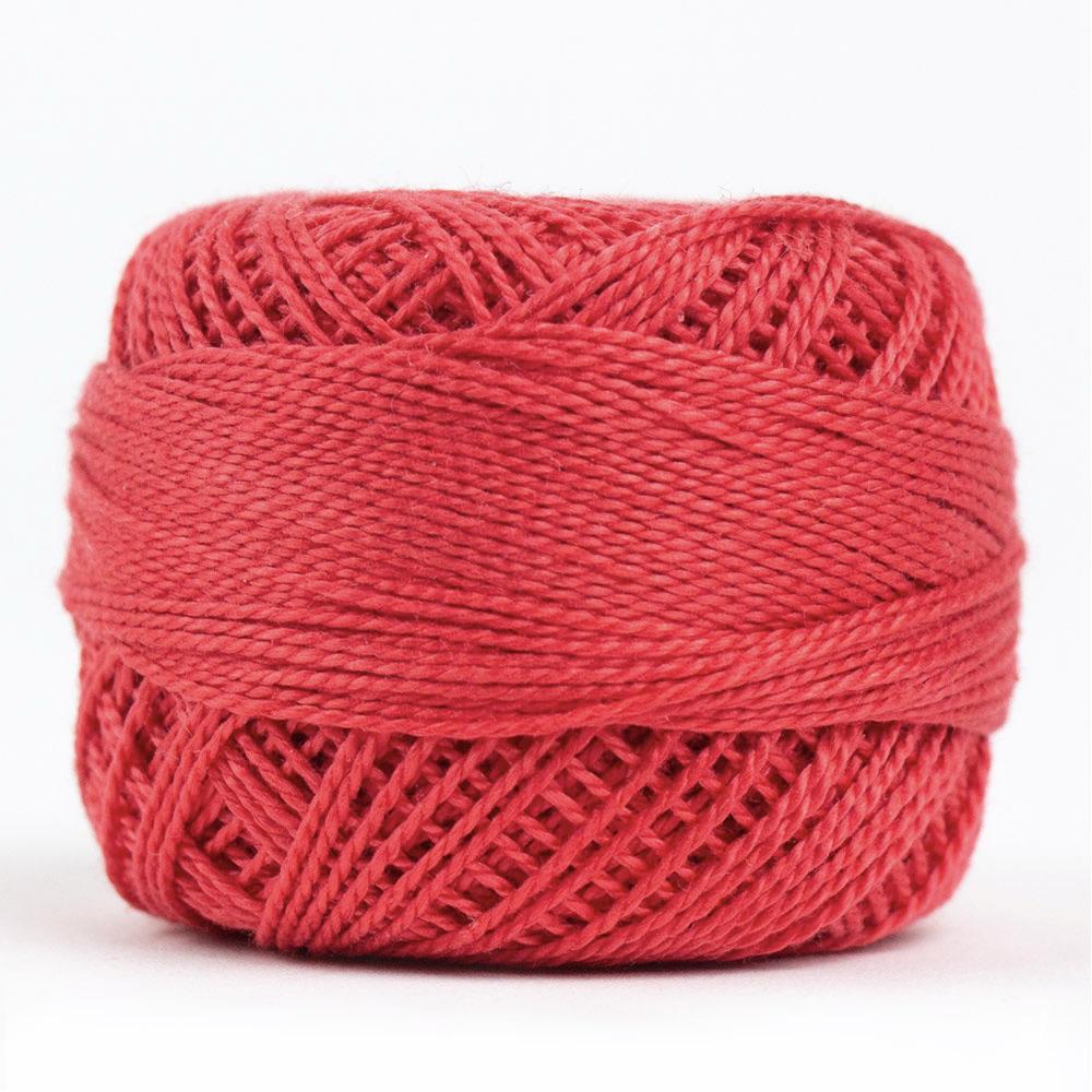 Side view of Perle cotton ball on white background to show color