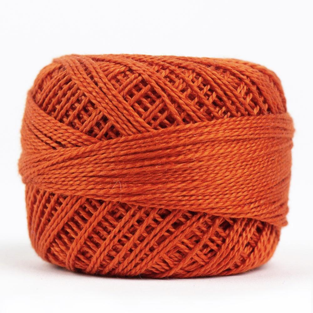 Side view of Perle cotton ball on white background to show color