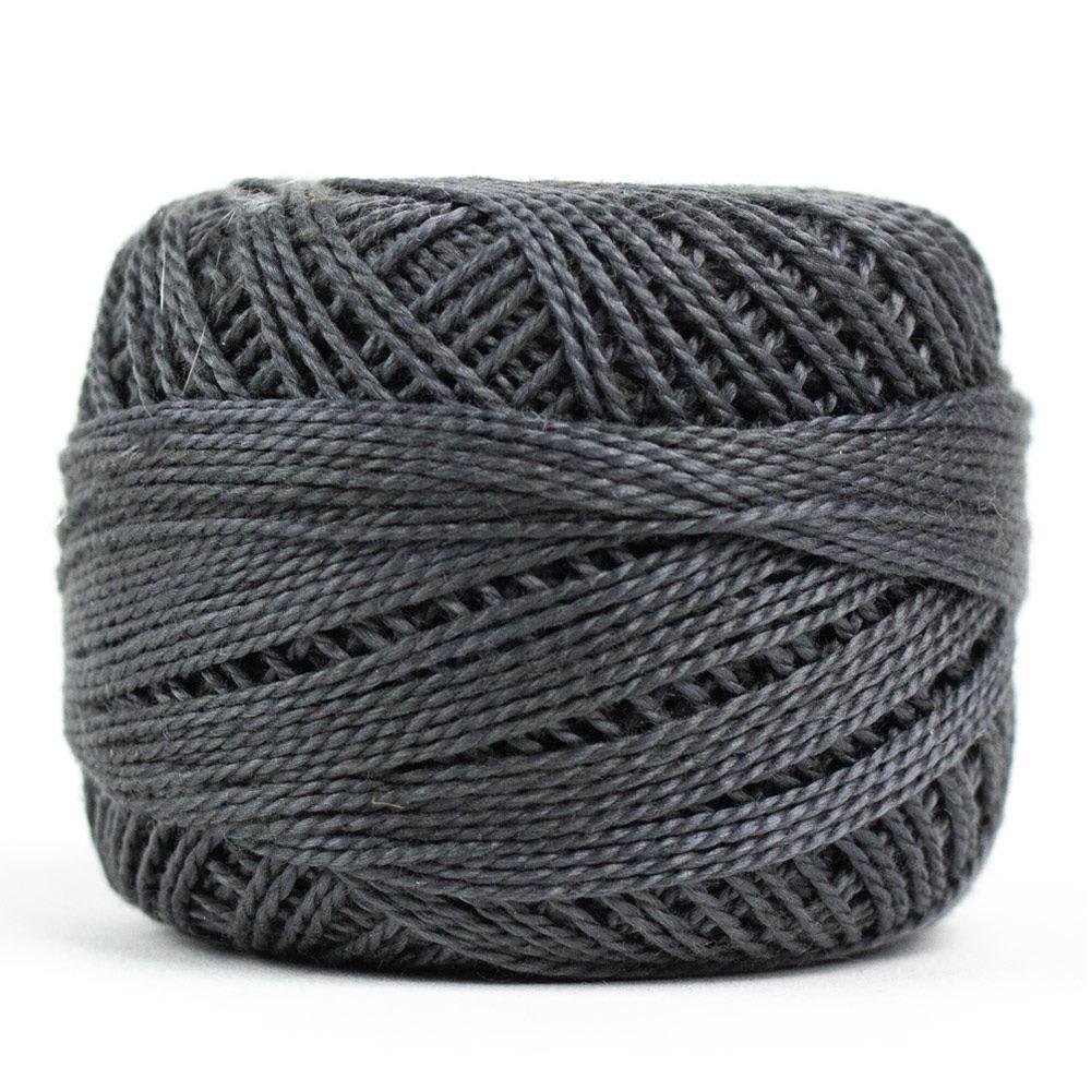 Side view of Perle cotton ball on white background to show color