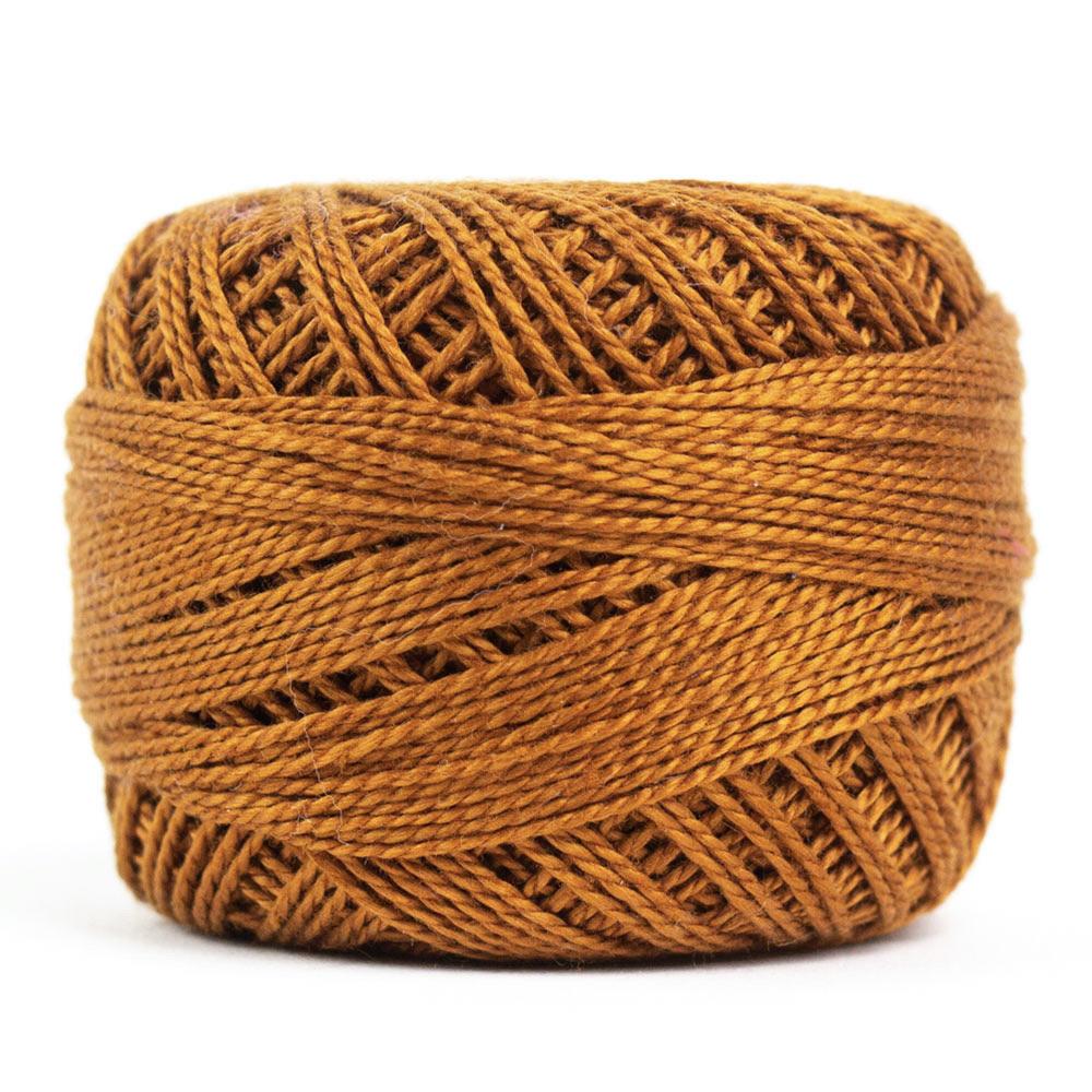 Side view of Perle cotton ball on white background to show color