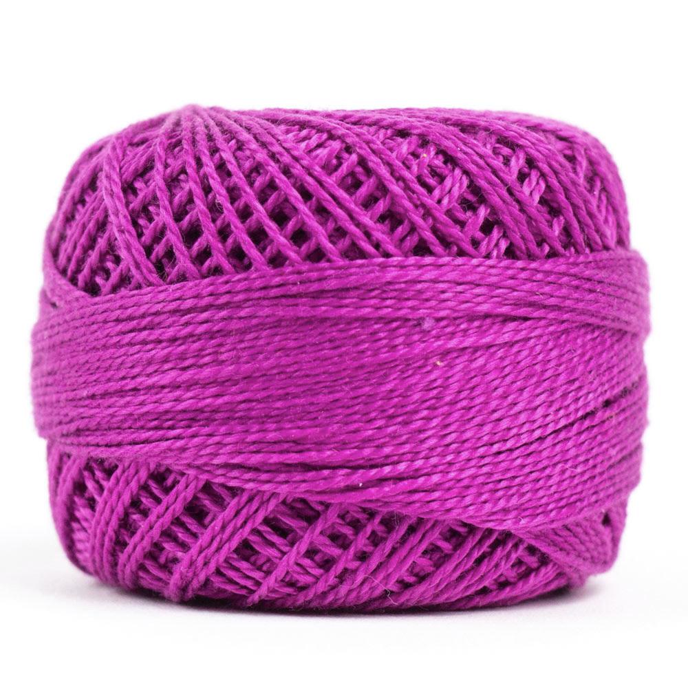 Side view of Perle cotton ball on white background to show color