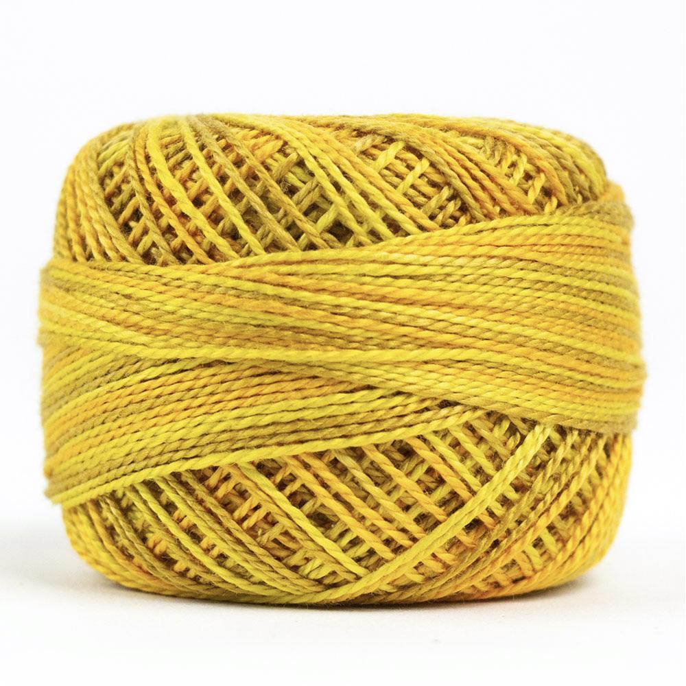 Side view of Perle cotton ball on white background to show color