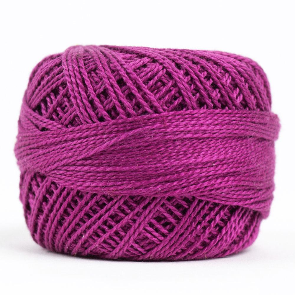 Side view of Perle cotton ball on white background to show color