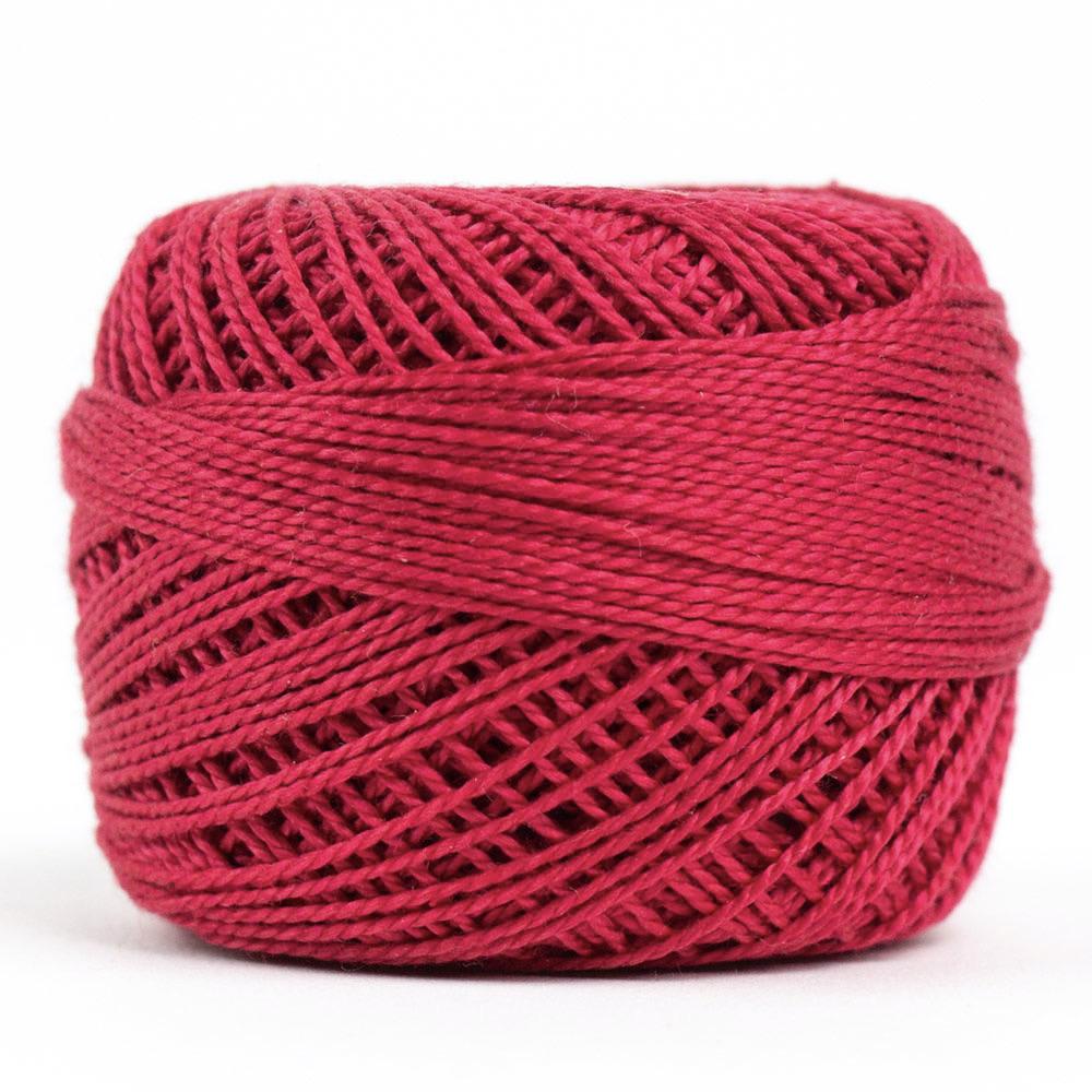 Side view of Perle cotton ball on white background to show color