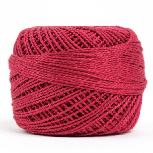 Side view of Perle cotton ball on white background to show color