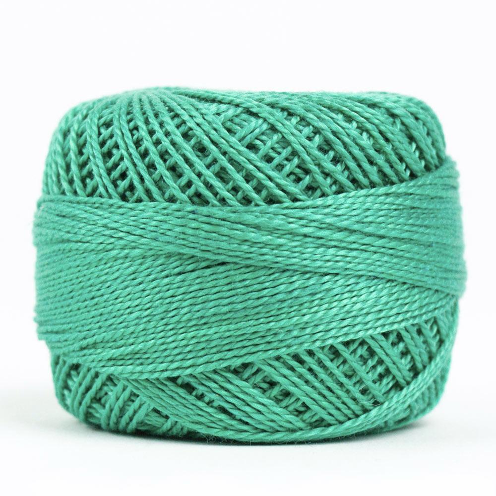 Side view of Perle cotton ball on white background to show color