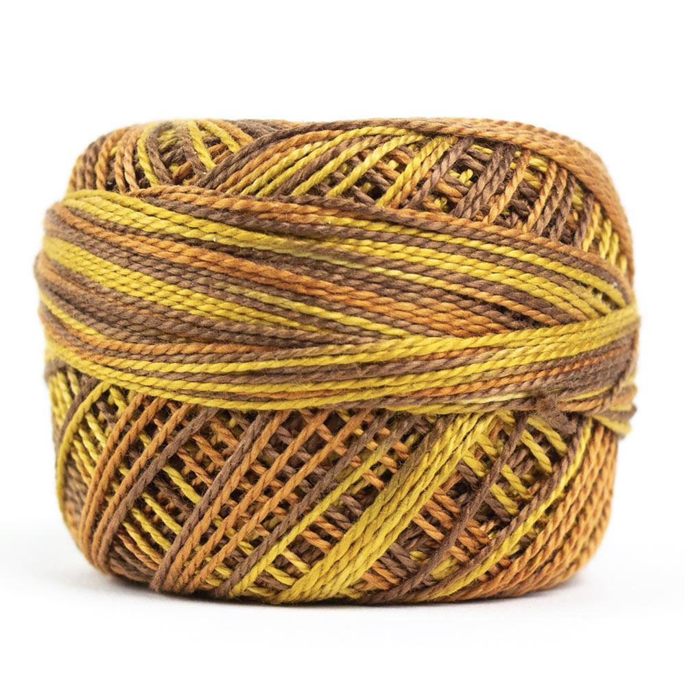 Side view of Perle cotton ball on white background to show color