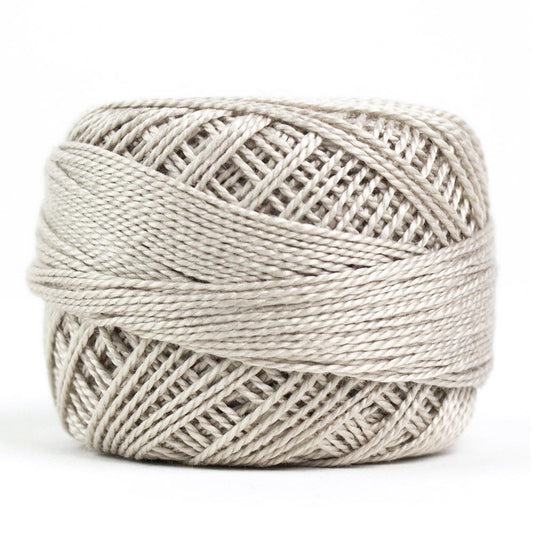 Side view of Perle cotton ball on white background to show color