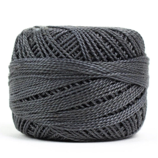 Side view of Perle cotton ball on white background to show color