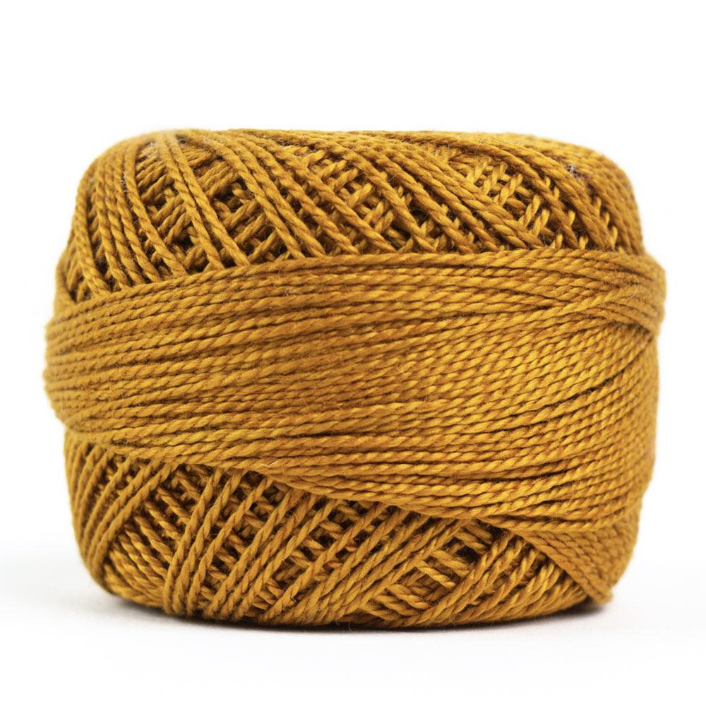 Side view of Perle cotton ball on white background to show color