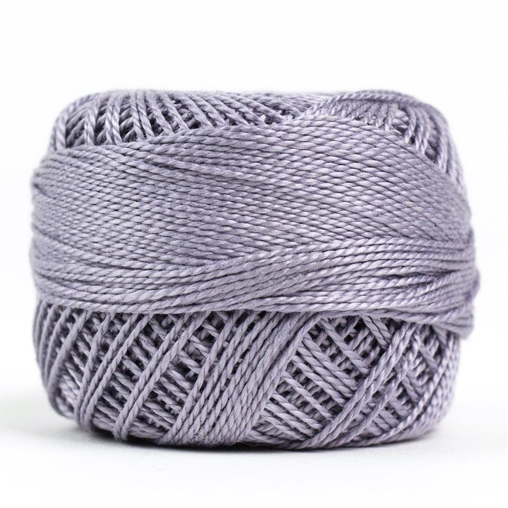 Side view of Perle cotton ball on white background to show color