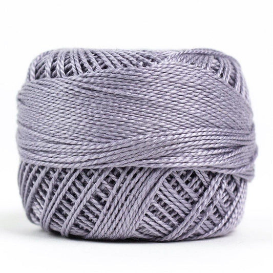 Side view of Perle cotton ball on white background to show color