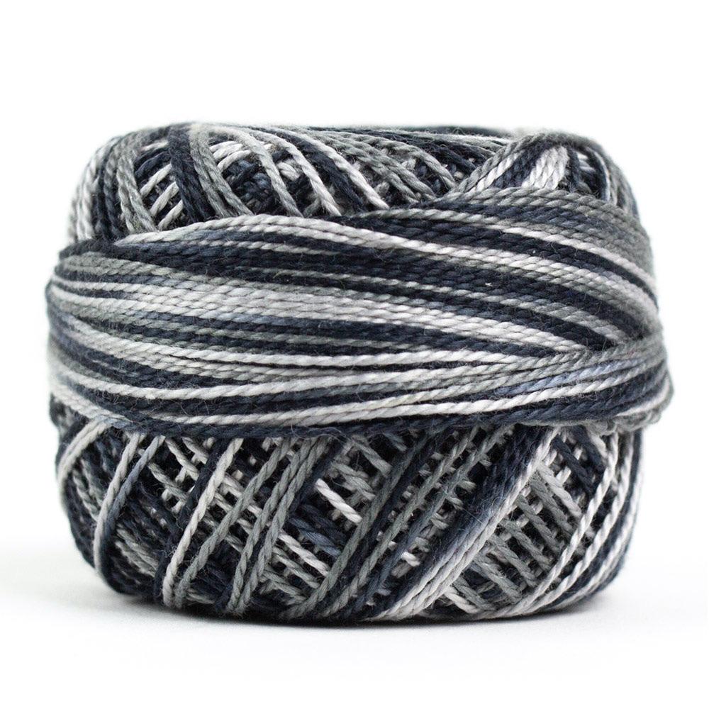 Side view of Perle cotton ball on white background to show color